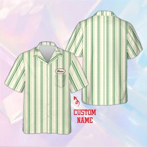 May include: A short-sleeved button-down shirt featuring a vertical green and cream striped pattern. The shirt includes a collar, a front pocket, and an oval-shaped patch on the chest with the text Name. The text CUSTOM NAME is also visible.