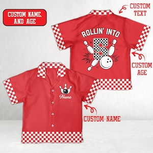 May include: Red bowling shirt with white and black checkered trim. The shirt features a bowling pin and ball graphic, with the text "ROLLIN' INTO" and the number 5. The shirt has space for a custom name and age.