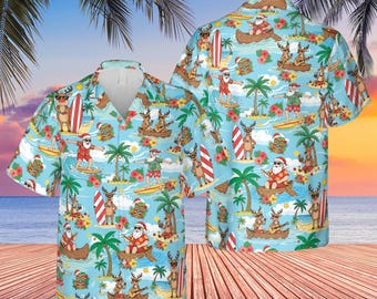May include: Light blue Hawaiian shirt with a Christmas theme. The shirt features Santa Claus and reindeer surfing, paddling canoes, and playing music amongst palm trees and tropical flowers. It has a button-down front and short sleeves.