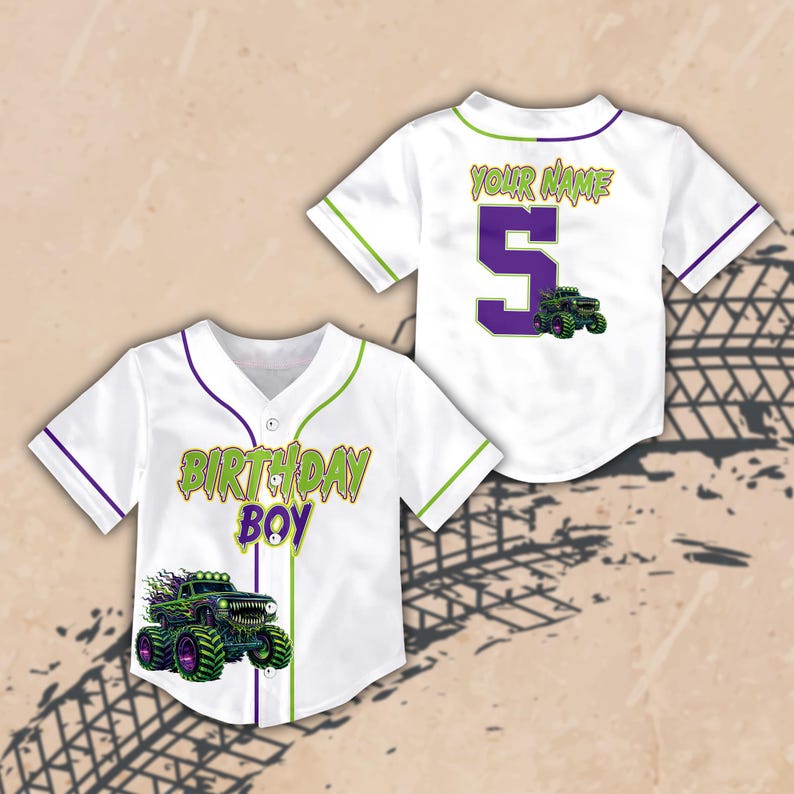 May include: Two white baseball jerseys with green and purple accents. One jersey says "BIRTHDAY BOY" with a monster truck graphic. The other jersey has the number "5" and the words "YOUR NAME" with a monster truck graphic.