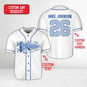 May include: A white baseball jersey with blue trim, featuring a front graphic of a blue gingham pennant with the text Kindergarten and School Name. The back displays the text Mrs. Johnson and the number 26 in blue gingham print.