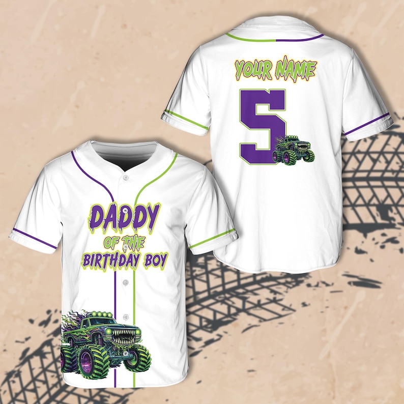 May include: White baseball jersey with green and purple accents. The front features the text "DADDY OF THE BIRTHDAY BOY" and a monster truck graphic. The back has the text "YOUR NAME", the number 5, and a monster truck graphic.
