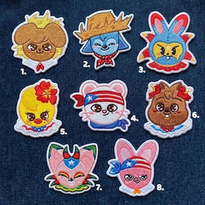 May include: A collection of eight embroidered patches featuring cartoon animal characters. Each patch has a unique design, including a dog, a blue creature with a cowboy hat, a rabbit, a mouse, a chick, and a squirrel. The patches are colorful and detailed.