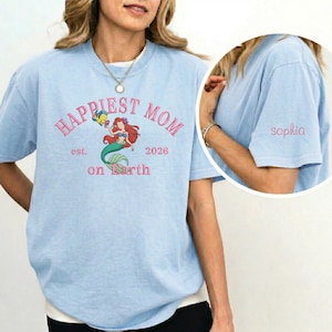 May include: A set of three ceramic mugs with a speckled, matte finish. The mugs are in shades of cream, light gray, and dark gray. Each mug has a simple, minimalist design and a rounded handle. The mugs are suitable for coffee or tea.