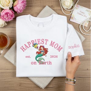 May include: A set of three ceramic mugs with a speckled, matte finish. The mugs are in shades of cream, light gray, and dark gray. Each mug has a simple, minimalist design and a rounded handle. The mugs are suitable for coffee or tea.