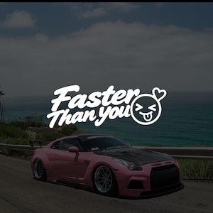 May include: A pink sports car with a black bonnet and a large rear wing parked on a road. The white text Faster Than You is displayed above the car, accompanied by a white circular icon featuring a winking face with a tongue out and a heart.