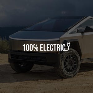 May include: A tan electric vehicle with a futuristic design, featuring a sloped front and angular body. The text "100% ELECTRIC" is displayed in white, along with an electric plug symbol. The vehicle has black wheels and is parked on a dirt track.