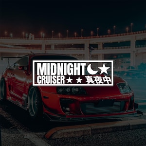 May include: A red sports car with the text "MIDNIGHT CRUISER" in a white rectangular box. The text includes a crescent moon and star symbol, and Japanese characters. The car is parked on a dark street with a bridge in the background.