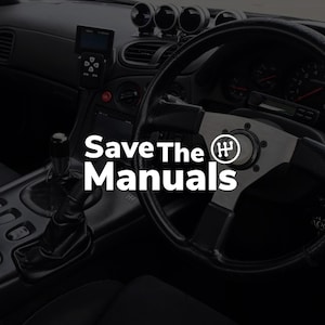 May include: Interior view of a car's dashboard, featuring a steering wheel, gear shift, and gauges. The text "Save The Manuals" is prominently displayed. The overall aesthetic is dark and sleek, suggesting a focus on automotive performance.