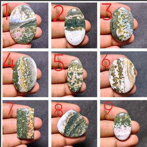 May include: A collection of nine polished ocean jasper cabochons in various shapes, including oval, rectangular, and triangular. Each stone features unique patterns of green, white, pink, and yellow orbicular inclusions and mineral banding.