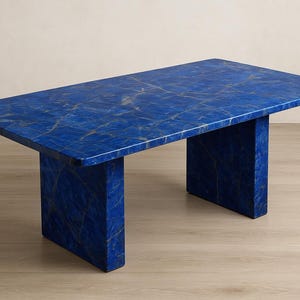 May include: A rectangular table with a vibrant blue surface and gold veining. The table has a solid, block-like base, and is made of a stone-like material. The table is approximately 60 inches long and 30 inches wide.