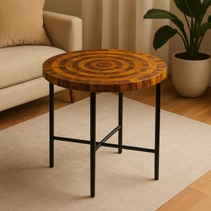 May include: A round side table with a mosaic wood top and black metal legs. The tabletop features a concentric circle design in shades of brown. The table is approximately 20 inches in diameter and 20 inches tall.