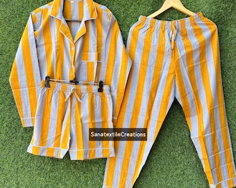 May include: A three-piece pajama set with a yellow and gray striped pattern. The set includes a long-sleeved button-down shirt, shorts, and long pants. The pajamas are displayed on hangers against a green background.