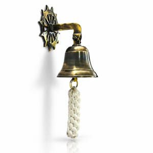 May include: A brass ship's bell with a rope pull, mounted on a wall. The bell is attached to a decorative wheel. The bell and wheel have a vintage, antique appearance. The rope is white.