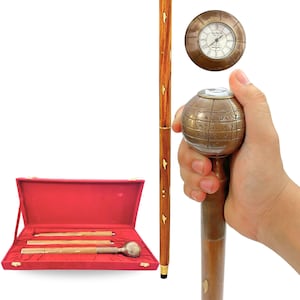 May include: A wooden walking cane with a brass globe handle and a brass clock face. The cane is in a red velvet box with a brass handle. The cane is brown with gold accents. The globe handle has engraved text.
