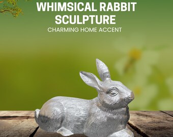 May include: A silver-colored rabbit sculpture in a relaxed pose. The sculpture has detailed fur texture and long ears. The text above the rabbit reads "WHIMSICAL RABBIT SCULPTURE CHARMING HOME ACCENT". The sculpture is on a wooden surface with a blurred green background.