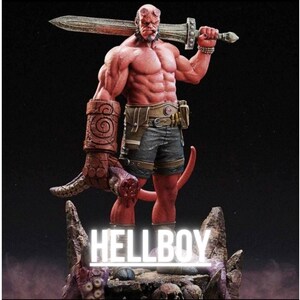 May include: A red-skinned Hellboy figurine holding a large sword. The figure is muscular and detailed, wearing shorts and a belt. The base of the figurine has the word "HELLBOY" in white neon. The overall theme is comic book and fantasy.