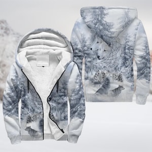 May include: A hooded zip-up jacket with a winter forest scene and wolf imagery. The jacket features a white sherpa lining and a detailed print of wolves, a dreamcatcher, and snow-covered trees. The design is repeated on the back.