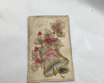 Vintage 1912/1915 embossed Christmas postcard with bell and holly