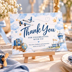 Puede incluir: Una tarjeta de agradecimiento rectangular con ilustraciones en acuarela de un avión azul, maletas apiladas, un globo terráqueo y una torre de control. El texto dice Thank You FOR CELEBRATING WITH US! Your love, kindness and generosity mean so much to us.