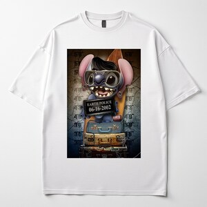 May include: White t-shirt with a cartoon character wearing sunglasses and holding a sign that reads "EARTH POLICE 06-16-2002." The character is standing on a stack of suitcases. The design is centered on the shirt.