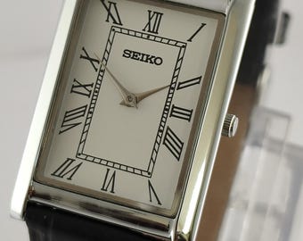 Reloj Seiko Slim Tank clásico vintage de cuarzo con esfera blanca y índices romanos para hombre