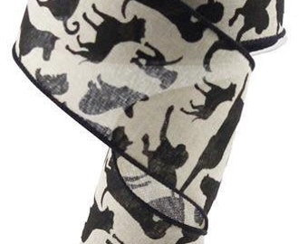 May include: A 2.5 inch wide wired ribbon with a black and white print of various dog silhouettes. The ribbon is made of a burlap-like material and has a wired edge for shaping.