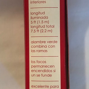 May include: A red and white box with the text "holiday time" and information about a string of lights. The lights are 5 feet long and have a total length of 7.5 feet. The lights are green and can be used indoors. The text also says that the lights are excellent for wreaths and trees.