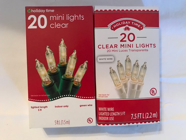 May include: Two boxes of 20 clear mini lights. The box on the left has green wire and is for indoor use only. The box on the right has white wire and is for indoor use. Both boxes have a lighted length of 5 feet.