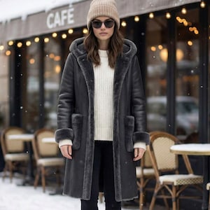 Women's Long Black Hooded Shearling Coat - Leather Winter Coat with Oversized Fur Patch Pockets