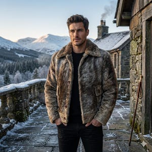 May include: A brown and grey faux fur jacket with a wide collar, long sleeves, and a button-front closure. The jacket features two front pockets with button flaps, worn over a plain black shirt and black trousers in a cold, snowy outdoor setting.