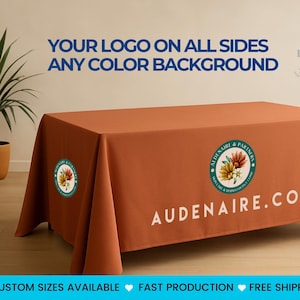 May include: A rust-colored table cover with the text "YOUR LOGO ON ALL SIDES ANY COLOR BACKGROUND" in blue. The cover has a company logo and website printed on it. The text "AUDENAIRE.COM" is visible. The image also includes text that says "CUSTOM SIZES AVAILABLE FAST PRODUCTION FREE SHIPPING IN THE USA".