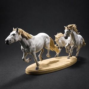 May include: A sculpture featuring two white horses with light tan manes and tails in a dynamic running pose. The horses are positioned on an oval, tan-colored base that mimics a sandy surface, capturing the motion of the animals in mid-stride.