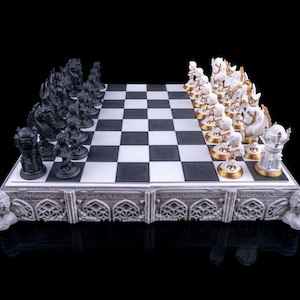 May include: A detailed chess set with black and white pieces arranged on a checkered board. The black pieces are dark, while the white pieces have gold accents. The board sits on a decorative base with ornate carvings.