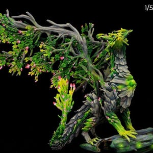 May include: A detailed sculpture of a mythical creature, part dragon and part tree. The figure is primarily green and gray, with branches and leaves forming its wings and head. Small pink flowers dot the branches, and the creature is perched on a wooden base.