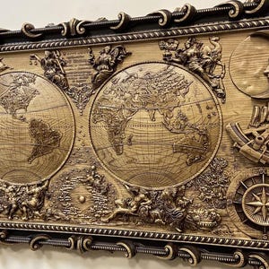 May include: A rectangular, wooden wall art piece with a detailed, carved world map design. The artwork features celestial elements like the sun and moon, along with nautical instruments. The frame is dark brown with ornate detailing, enhancing the antique aesthetic.