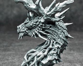 May include: A detailed, gray dragon bust sculpture. The dragon features intricate scales, sharp horns, and a flowing mane. The sculpture is mounted on a circular base, showcasing a fantasy art theme.
