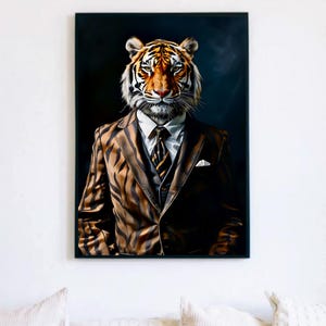 May include: A framed art print featuring a tiger's head wearing a brown striped suit, white shirt, and patterned tie. The artwork has a dark background and is displayed on a white wall.
