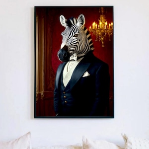 Op de afbeelding: Een ingelijste kunstdruk met een zebra in een zwarte smoking, wit overhemd en vlinderdas. De achtergrond is een rode muur met een gouden kroonluchter. De zebra heeft zwart-witte strepen.
