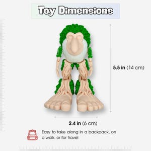 May include: A quirky toy figure with a green, leafy head and limbs, and a light beige face and feet. The toy is 14 cm tall and 6 cm wide. The image includes the text: "Easy to take along in a backpack, on a walk, or for travel."