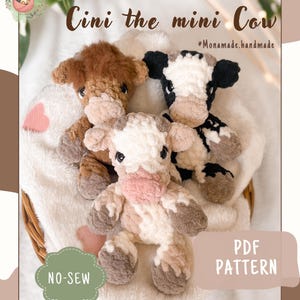 May include: Three crocheted plush cow toys in brown, black and white, and tan and white. The text reads Cini the mini Cow, Monamade.handmade, NO-SEW, and PDF PATTERN. The toys feature dark eyes and soft yarn textures, arranged together in a small basket.