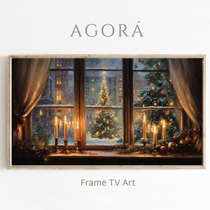 May include: A framed digital art print depicting a cozy Christmas scene. The artwork shows a window view with a decorated Christmas tree, lit candles, and falling snow. The text "AGORÁ" and "Frame TV Art" are visible.