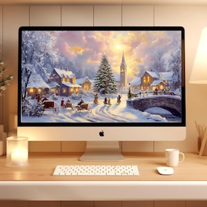 May include: A desktop computer displays a winter landscape painting with a church, houses, and people in horse-drawn carriages. The scene is set in a snowy village with a bridge. A lamp, candles, and a keyboard are on the desk.