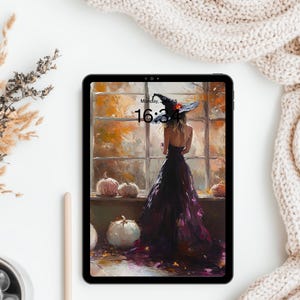 May include: A black tablet displaying a digital illustration of a person in a dark gown and witch hat standing before a window with autumn foliage and pumpkins. The screen shows the time 16:34 and the text Monday, July 18 in black font.