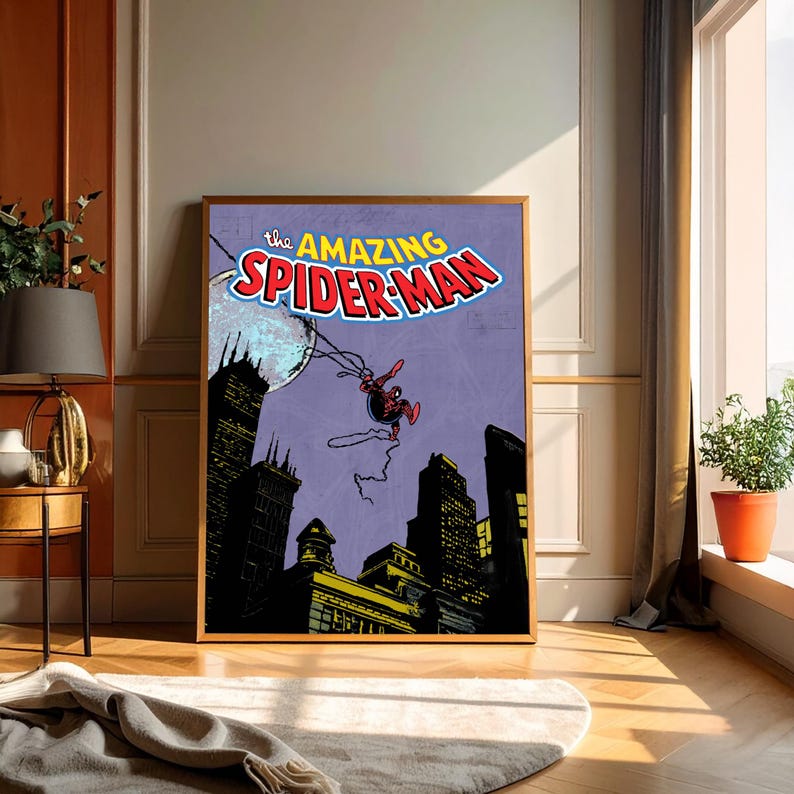 May include: Framed vintage comic book art featuring Spider-Man swinging over a city skyline. The title "The Amazing Spider-Man" is displayed in bold, colorful lettering. The artwork has a retro comic book style with a purple background.