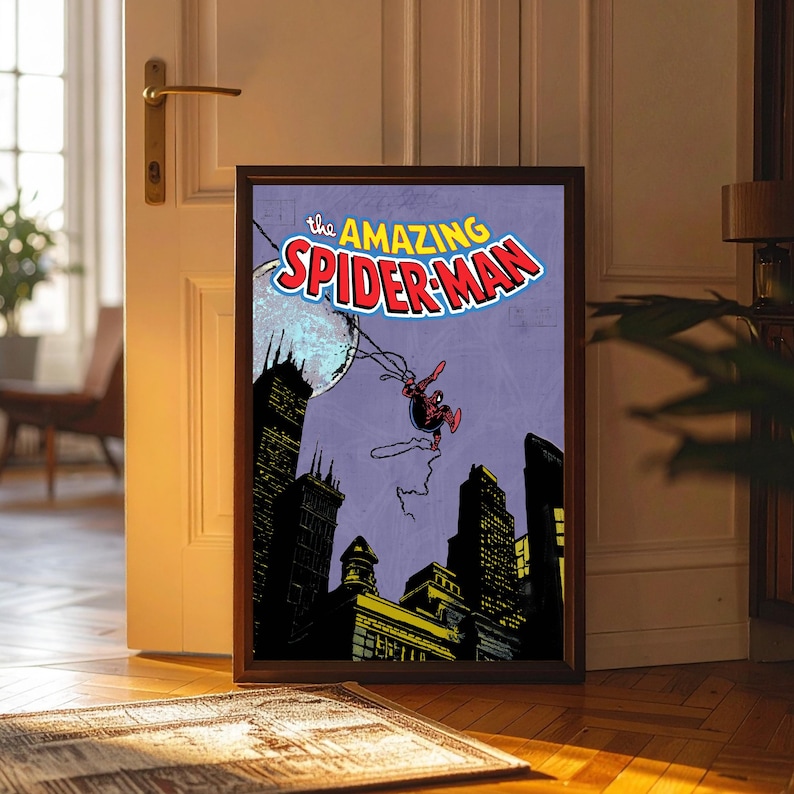 May include: Framed comic book art featuring Spider-Man swinging through a city at night. The title "The Amazing Spider-Man" is displayed in a colorful font. The artwork is set against a purple background with a full moon.