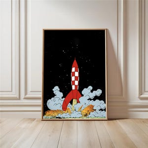 Może przedstawiać: Oprawiony wydruk przedstawiający czerwoną i białą rakietę startującą w czarne, gwiaździste niebo. Rakieta ma wzór w szachownicę i jest otoczona dymem i płomieniami. Grafika w stylu komiksowym.