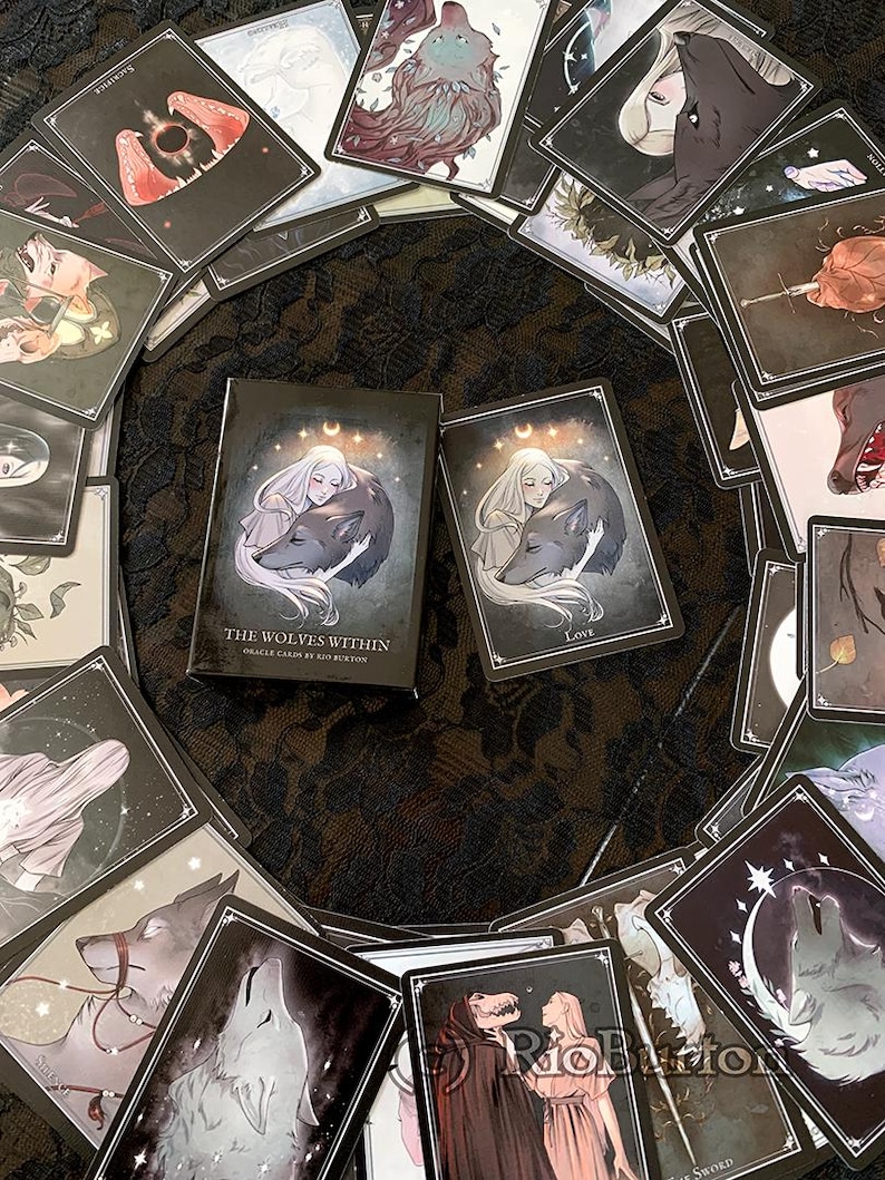 May include: A deck of oracle cards called "The Wolves Within" by Ritu Burton. The cards feature illustrations of wolves and women in a dark, mystical style. The box is black with silver lettering and a crescent moon design.