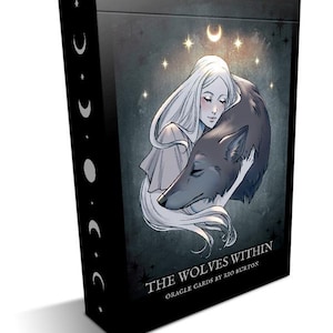 May include: A black box with a white and gray illustration of a woman holding a wolf. The box has the text "The Wolves Within Oracle Cards by Rio Burton" on the front.