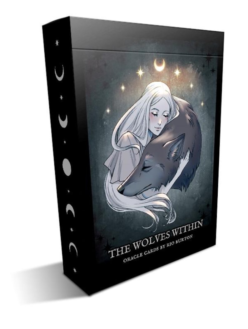 May include: A black box with a white and gray illustration of a woman holding a wolf. The box has the text "The Wolves Within Oracle Cards by Rio Burton" on the front.